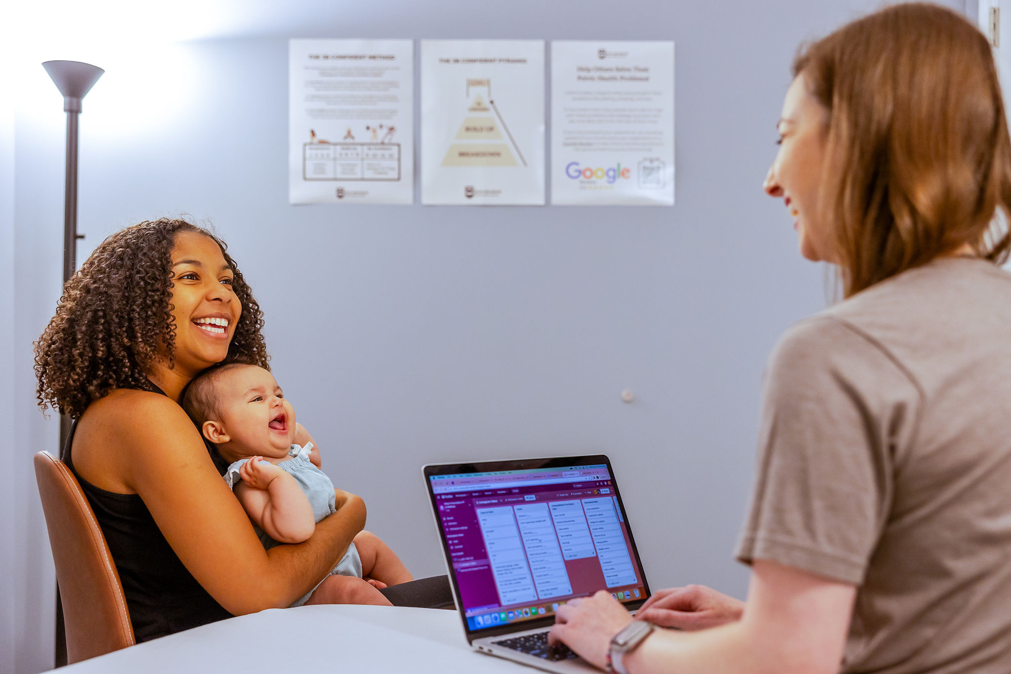 Mom with her baby talking with employee Pelvic Prescription
